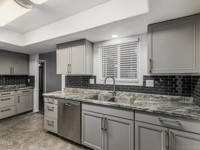 Updated kitchen with granite countertops, modern cabinetry, and sleek finishes. This Sun City home delivers both style and functionality.