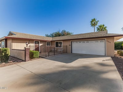 Wide driveway with attached two-car garage and private patio entry. This Sun City home combines convenience, functionality, and well-maintained exterior features.