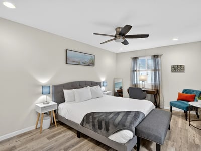 Bright and airy primary bedroom with modern flooring, workspace, and natural light designed for relaxation in this Scottsdale residence.