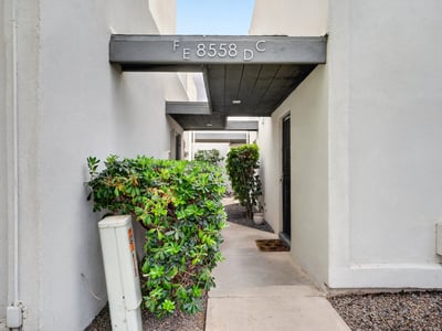 Quiet Scottsdale entry courtyard with covered patio and desert landscaping provides a peaceful, low-maintenance outdoor space.