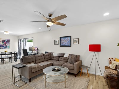 Light-filled Scottsdale living space with ceiling fan, updated flooring, and open-concept design that enhances comfort and functionality.