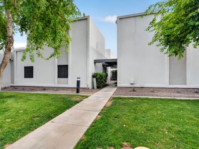 Attractive Scottsdale exterior with green lawn, mature trees, and clean design offering great curb appeal and community atmosphere.