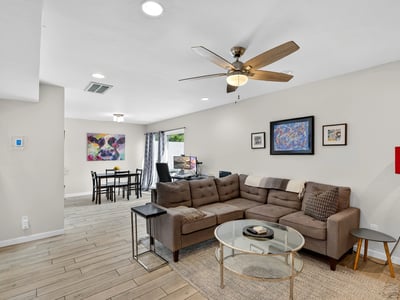 Light-filled Scottsdale living and dining space with open layout, modern finishes, and ceiling fan perfect for entertaining and daily living.