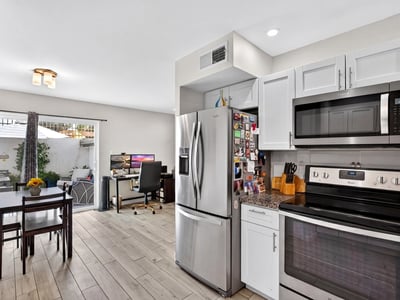 Functional Scottsdale kitchen and dining space with modern finishes, built-in workspace, and direct patio access ideal for everyday living and entertaining.