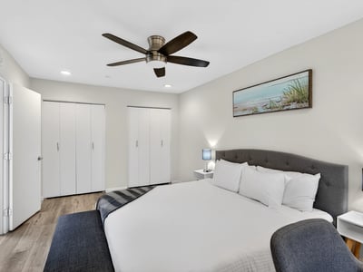 Scottsdale primary bedroom offering dual closets, modern flooring, and a spacious layout designed for comfort and organized living.