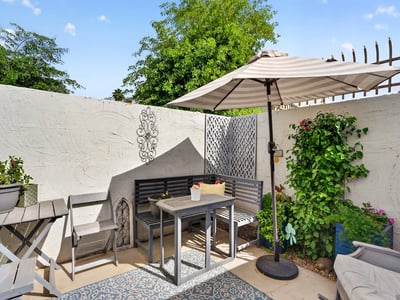 Comfortable Scottsdale patio with seating, shade, and garden accents, creating a warm and welcoming outdoor space.
