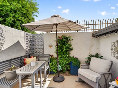 Peaceful Scottsdale patio with umbrella, seating, and landscaped touches, ideal for enjoying quiet outdoor moments.