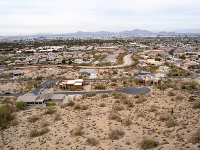 Featured aerial view of this spacious hillside lot showcasing elevated terrain and scenic desert beauty. Perfect for a luxury custom home near South Mountain Preserve and outdoor recreation.