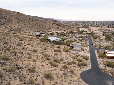 Wide panoramic aerial view capturing stunning desert landscapes, valley scenery, and hillside surroundings. This luxury Phoenix homesite offers privacy, views, and custom home potential in a scenic setting.