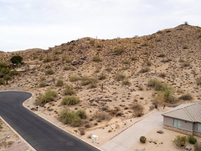 Expansive desert hillside lot offering panoramic mountain scenery and surrounding luxury homes. Located in Phoenix, this elevated property provides the ideal setting for a private custom retreat.