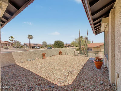 Relax and enjoy the beauty of Fountain Hills from this inviting front outdoor space. The combination of mountain views, desert landscaping, and privacy creates a peaceful environment to unwind.