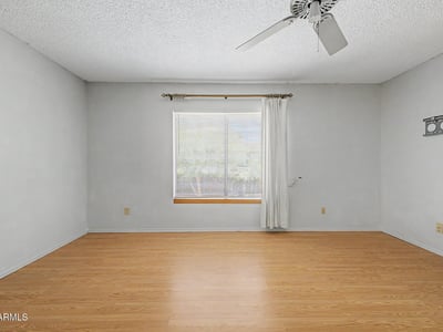 Featuring abundant natural light and attractive flooring, this spacious owner's suite provides a peaceful retreat within the home. The flexible layout allows room for additional seating, workspace, or personalized furnishings.