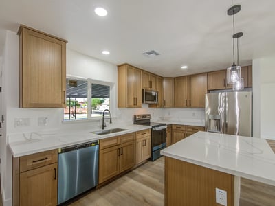 Thoughtfully remodeled with 42-inch white oak cabinetry, quartz countertops, stainless steel appliances, and a spacious island, this kitchen blends beauty with everyday functionality.