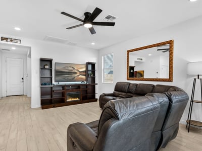 This welcoming living area showcases an open-concept design with modern finishes, abundant natural light, and comfortable gathering spaces that flow seamlessly throughout the home.