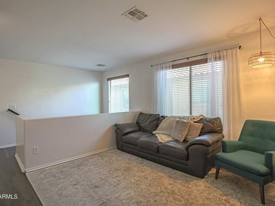 Open upstairs loft featuring updated flooring and flexible living space that's ideal for a home office, media room, homework station, or additional family lounge.