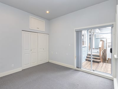 Bright, versatile room with large closet and direct access to a private outdoor space.