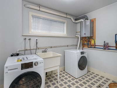 Bright laundry room featuring modern appliances, ample storage, and convenient hookups for all your laundry needs.