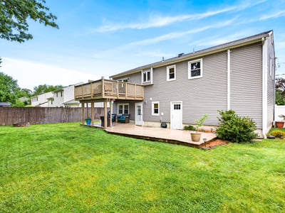 Spacious backyard with large deck and patio.