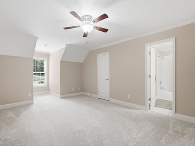 Spacious, multi-functional room featuring plush carpet, natural light, and an en-suite bathroom for convenience.