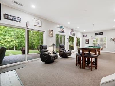 Spacious indoor entertainment area with panoramic views, perfect for gatherings and enjoying nature.