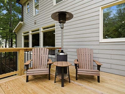 Cozy outdoor space featuring comfortable seating and a patio heater, perfect for year-round relaxation.