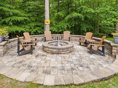 Inviting fire pit area surrounded by nature, perfect for gatherings and cozy evenings outdoors.