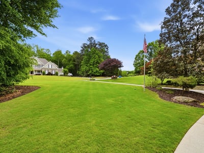 Expansive, well-maintained grounds offer ample space for outdoor activities and potential landscaping projects.