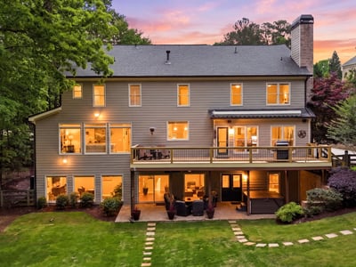 Spacious home with large windows and a welcoming deck, perfect for entertaining and enjoying outdoor views.