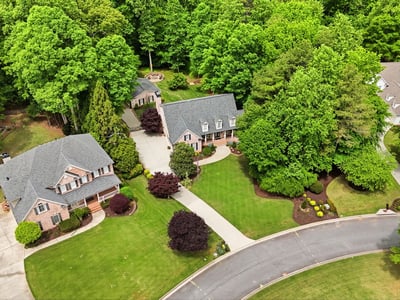 Discover a picturesque neighborhood featuring spacious homes surrounded by lush greenery and beautifully landscaped yards.