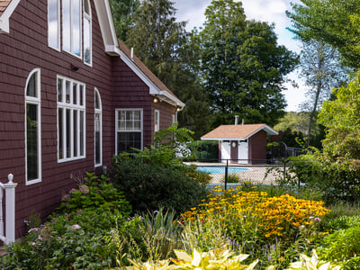 This inviting home features a lush garden, a private pool area, and picturesque outdoor views.
