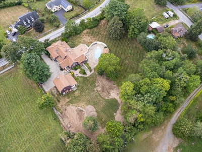 Stunning property featuring a spacious home, inviting pool, and expansive landscaped grounds in a peaceful setting.
