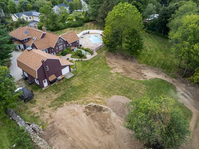Spacious property featuring a large pool area, surrounded by lush greenery and ample outdoor space.
