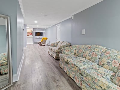 Bright and spacious lower level featuring a cozy seating area and convenient access to entertainment options.