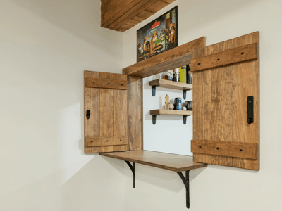 This unique nook features rustic wooden shutters and shelving, perfect for displaying decor or storing essentials.
