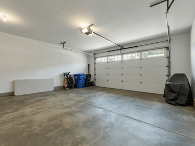 Spacious garage with ample room for storage and parking, featuring a modern overhead door.