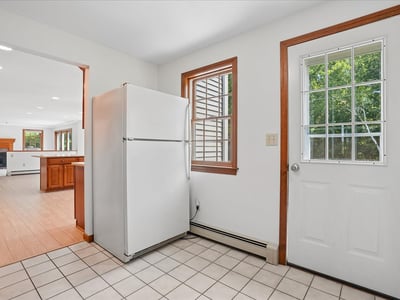 Bright kitchen area featuring convenient access to outdoor space and spacious layout, perfect for entertaining.