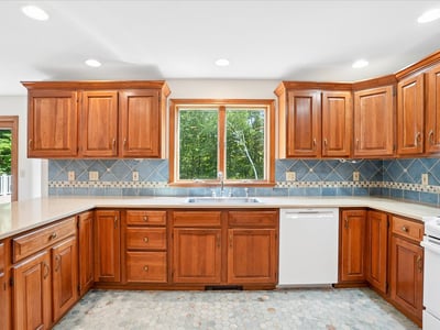 This functional kitchen features rich wood cabinetry, ample counter space, and bright natural light.