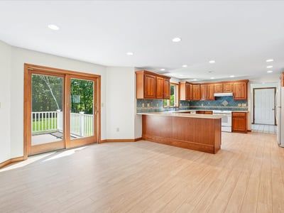 Modern kitchen featuring ample natural light, updated cabinetry, and direct access to an outdoor deck.