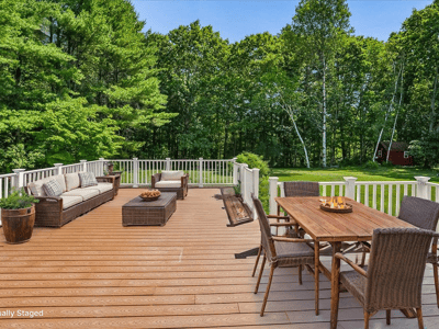 Spacious outdoor deck perfect for entertaining, surrounded by lush greenery and a tranquil atmosphere.