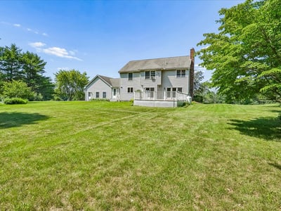 Spacious home surrounded by lush greenery, offering a peaceful retreat with ample outdoor space.