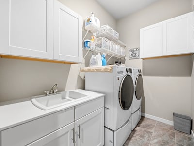 Laundry room off of the entry and walks through to primary suite.