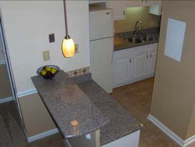 Bright kitchen featuring modern appliances, ample counter space, and a cozy breakfast bar for casual dining.
