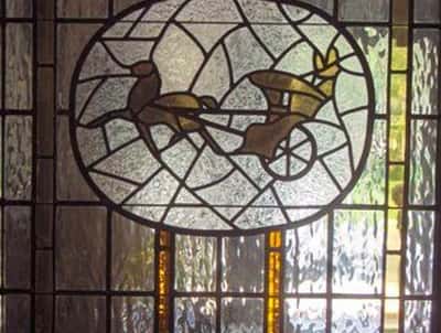Stunning stained glass artwork featuring intricately designed bicycles, adding unique character to the space.