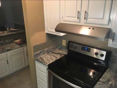 Modern kitchen featuring stainless steel appliances and sleek countertops, perfect for culinary enthusiasts and entertaining.