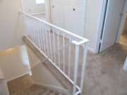 Bright and airy landing with modern railing, offering a welcoming entryway to the upper living spaces.