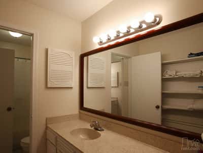 Modern bathroom featuring a spacious countertop, ample storage, and well-lit mirror for daily convenience.