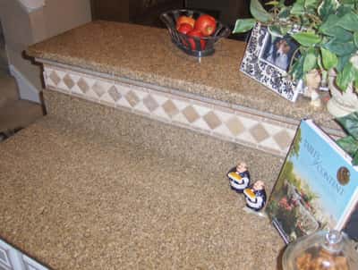 This well-appointed kitchen features a stunning granite countertop with decorative tile accents and thoughtful decor.
