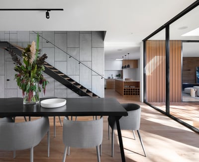 Contemporary open-concept dining area featuring stylish decor, abundant natural light, and seamless indoor-outdoor flow.