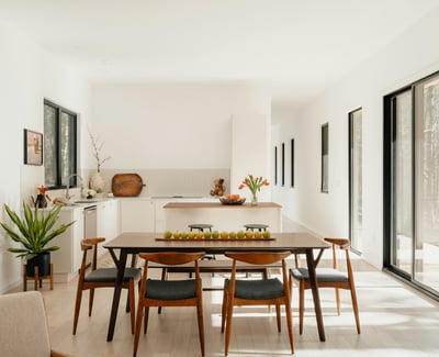Bright and airy open-concept kitchen and dining area, featuring modern furnishings and abundant natural light.