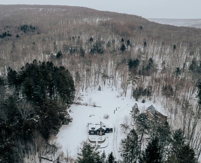 Nestled in a vast snowy landscape, this secluded property offers privacy and natural beauty year-round.